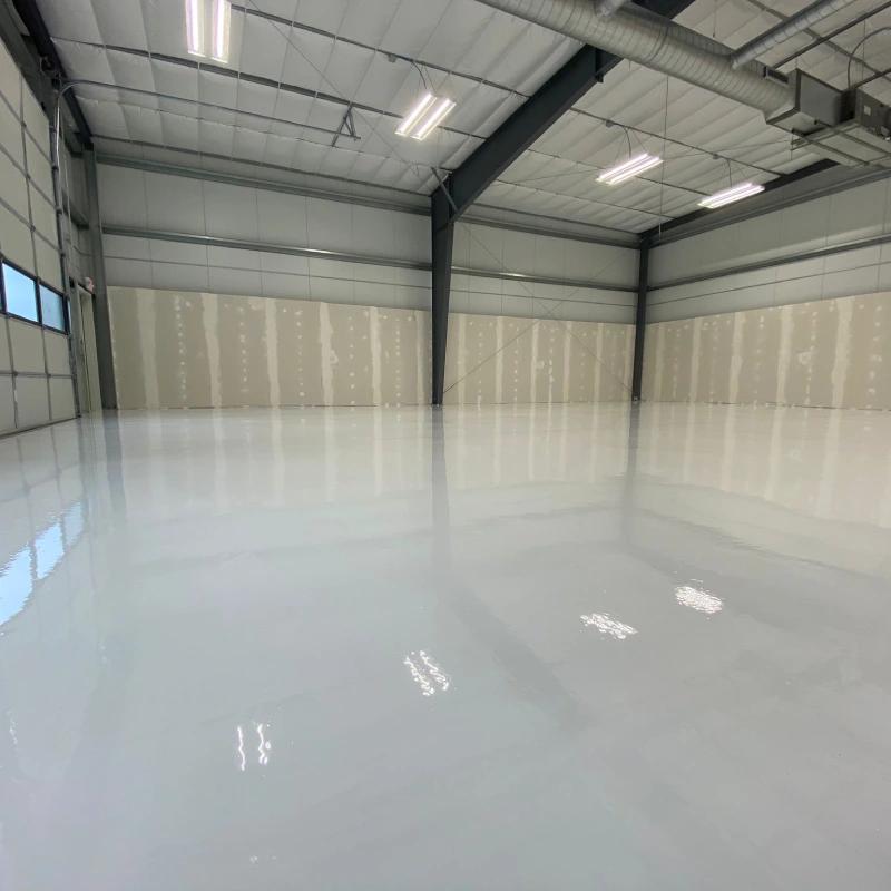 Professional epoxy flooring team applying coating in UAE